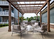 Thumbnail 37 of 74 - Two chairs and a table are on a patio at Waterleaf at Neely Ferry Apartments, South Carolina