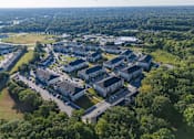 Thumbnail 43 of 74 - A bird's eye view of a large residential complex surrounded by trees at Waterleaf at Neely Ferry Apartments, South Carolina