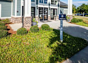 Thumbnail 45 of 74 - A building with a white and grey facade has a sign in front of it at Waterleaf at Neely Ferry Apartments, Simpsonville, SC 29680