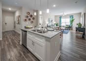Thumbnail 71 of 74 - A modern kitchen with a large island and wooden floors at Waterleaf at Neely Ferry Apartments, South Carolina