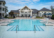 Thumbnail 56 of 74 - A large swimming pool in front of a building at Waterleaf at Neely Ferry Apartments, Simpsonville