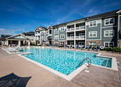Thumbnail 53 of 74 - A large swimming pool in front of apartment buildings at Waterleaf at Neely Ferry Apartments, Simpsonville, SC
