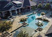 Thumbnail 8 of 30 - an aerial view of a swimming pool in front of a house