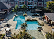 Thumbnail 9 of 30 - an aerial view of a swimming pool with lounge chairs and umbrellas