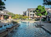 Thumbnail 6 of 30 - a swimming pool with a building in the background