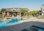 Thumbnail 7 of 30 - a swimming pool with a building in the background