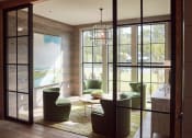 Thumbnail 7 of 32 - a living room with green chairs and a table and glass doors at Bellary Flats Apartments, Summerville , 29486