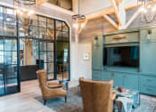 Thumbnail 8 of 32 - a living room with chairs and a tv at Bellary Flats Apartments, South Carolina