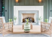 Thumbnail 2 of 32 - an outdoor patio with a fireplace and tables and chairs at Bellary Flats Apartments, Summerville
