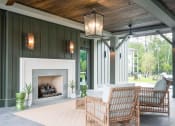 Thumbnail 5 of 32 - a covered patio with a fireplace at Bellary Flats Apartments, Summerville , SC 29486
