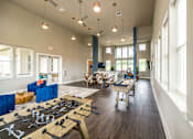 Thumbnail 9 of 20 - A room with a foosball table in the middle of it.
