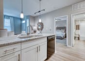 Thumbnail 37 of 39 - a kitchen with a sink and a door to a bedroom at Citadel at Westpointe, San Antonio, TX, 78251