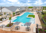 Thumbnail 2 of 39 - an aerial view of a swimming pool with chairs and umbrellas at Citadel at Westpointe, San Antonio, Texas