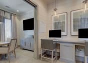 Thumbnail 20 of 39 - a room with a desk and chairs and a television at Citadel at Westpointe, San Antonio