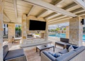 Thumbnail 3 of 39 - a living room with a fireplace and a television at Citadel at Westpointe, San Antonio, TX