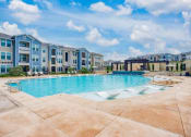 Thumbnail 2 of 15 - a large swimming pool with an apartment building in the background  at Edge and Stone, Texas