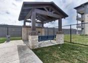 Thumbnail 4 of 18 - a picnic area with a bench in front of a fence at Legacy Flats, San Antonio, 78254