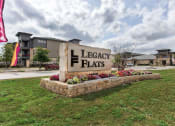 Thumbnail 1 of 18 - the sign for legacy flats in front of a building at Legacy Flats, San Antonio, TX 78254