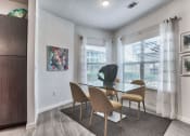 Thumbnail 8 of 18 - a dining room with a glass table and chairs at Legacy Flats, Texas