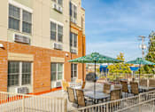 Thumbnail 5 of 18 - our apartments have a patio with tables and chairs and umbrellas