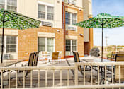 Thumbnail 3 of 18 - our apartments offer a patio with tables and chairs and umbrellas