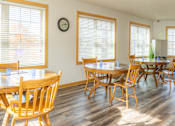 Thumbnail 10 of 18 - a dining room with tables and chairs and a clock on the wall