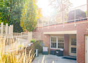 Thumbnail 6 of 18 - a brick building with a balcony and a patio with furniture