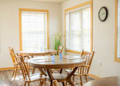 Thumbnail 11 of 18 - a dining room with two tables and chairs and two windows