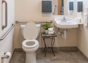 Thumbnail 18 of 18 - a bathroom with a toilet and a sink and a mirror