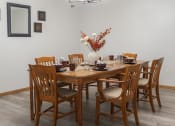 Thumbnail 3 of 35 - a dining room with a wooden table and chairs