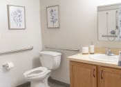 Thumbnail 10 of 35 - a bathroom with a toilet and a sink and a mirror