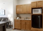 Thumbnail 15 of 35 - a kitchen with wooden cabinets and a microwave and a sink
