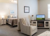 Thumbnail 17 of 35 - a living room with a couch and a tv and a bed