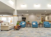 Thumbnail 22 of 35 - the lobby of the community center with couches and chairs