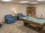 Thumbnail 23 of 35 - a game room with a pool table and chairs