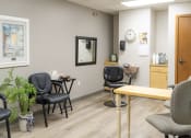 Thumbnail 24 of 35 - a waiting room at a physicians office with chairs and a table