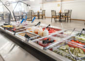 Thumbnail 32 of 35 - a buffet of food in a cafeteria with tables and chairs