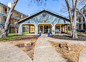 Thumbnail 2 of 28 - A blue building with the words "Leasing Entrance" on it.