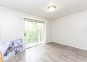 Thumbnail 13 of 19 - an empty living room with a sliding glass door to a patio
