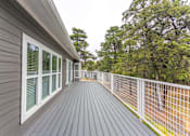 Thumbnail 10 of 19 - the view from the deck of a home with a white fence