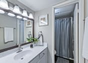 Thumbnail 17 of 17 - a bathroom with a sink and a mirror and a shower