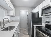 Thumbnail 13 of 17 - a kitchen with stainless steel appliances and white cabinets