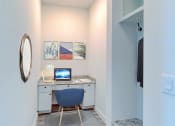 Thumbnail 6 of 23 - a desk with a computer and a chair in a room