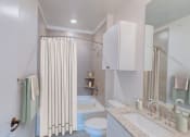 Thumbnail 6 of 14 - a bathroom with a shower curtain and a toilet and a sink