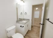 Thumbnail 6 of 21 - a bathroom with a toilet and a sink