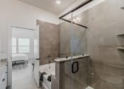Thumbnail 9 of 23 - a bathroom with a shower and a tub and a bed