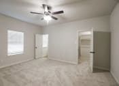 Thumbnail 9 of 21 - an empty bedroom with a ceiling fan and a closet