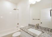 Thumbnail 11 of 21 - a bathroom with a sink and a tub and a toilet