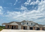 Thumbnail 21 of 21 - a large house with a cloudy sky above it
