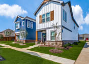 Thumbnail 2 of 20 - a blue and white house with a sidewalk in front of it